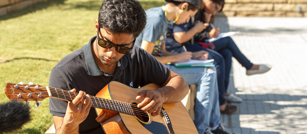 A student playing guitar